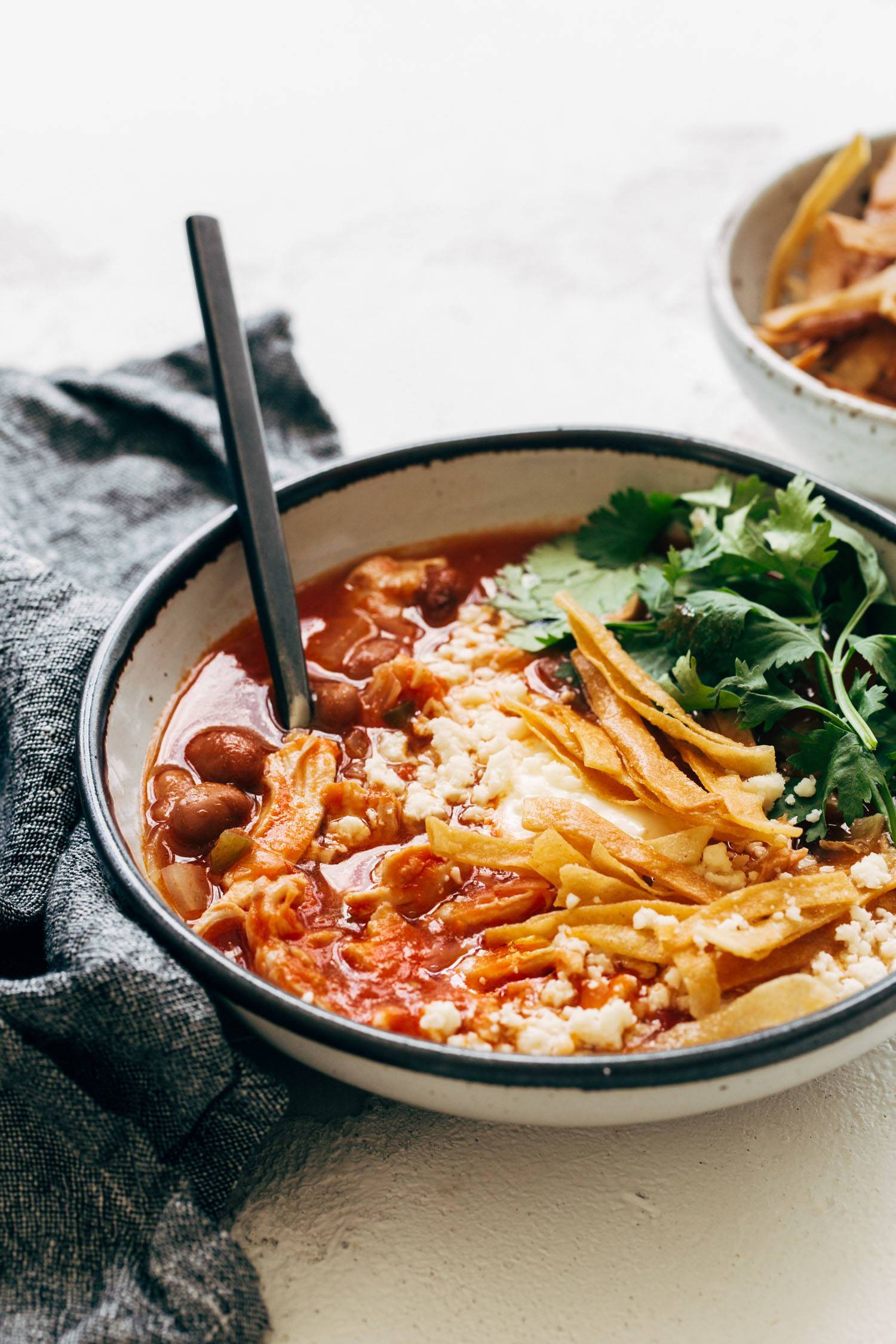 Chicken Tortilla Soup in a bowl with toppings.