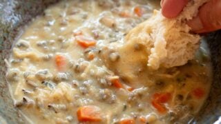 Crockpot Chicken Wild Rice Soup in a bowl with bread dip