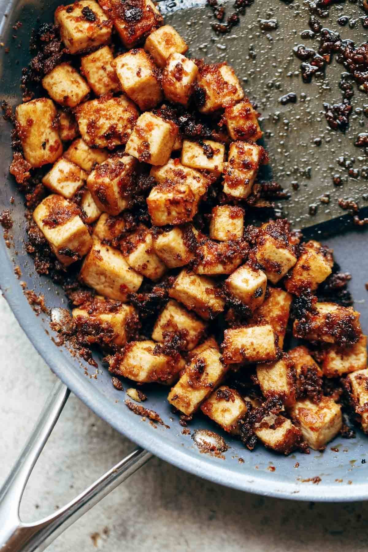 Tofu in a frying pan.