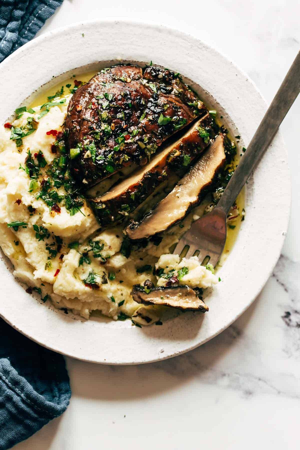 Grilled portobello sliced on top of goat cheese mashed potatoes.