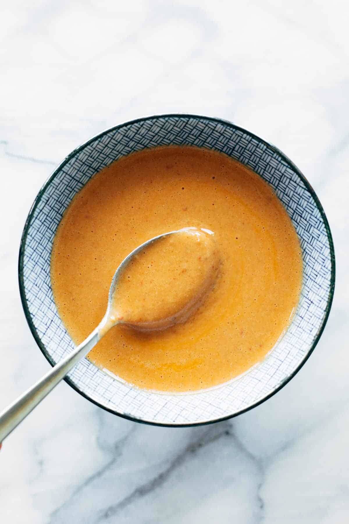 Chipotle tahini in a bowl with a spoon.