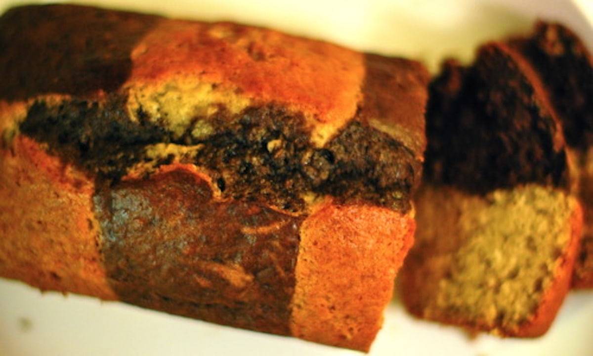 Loaf of chocolate checkered banana bread cut into pieces.