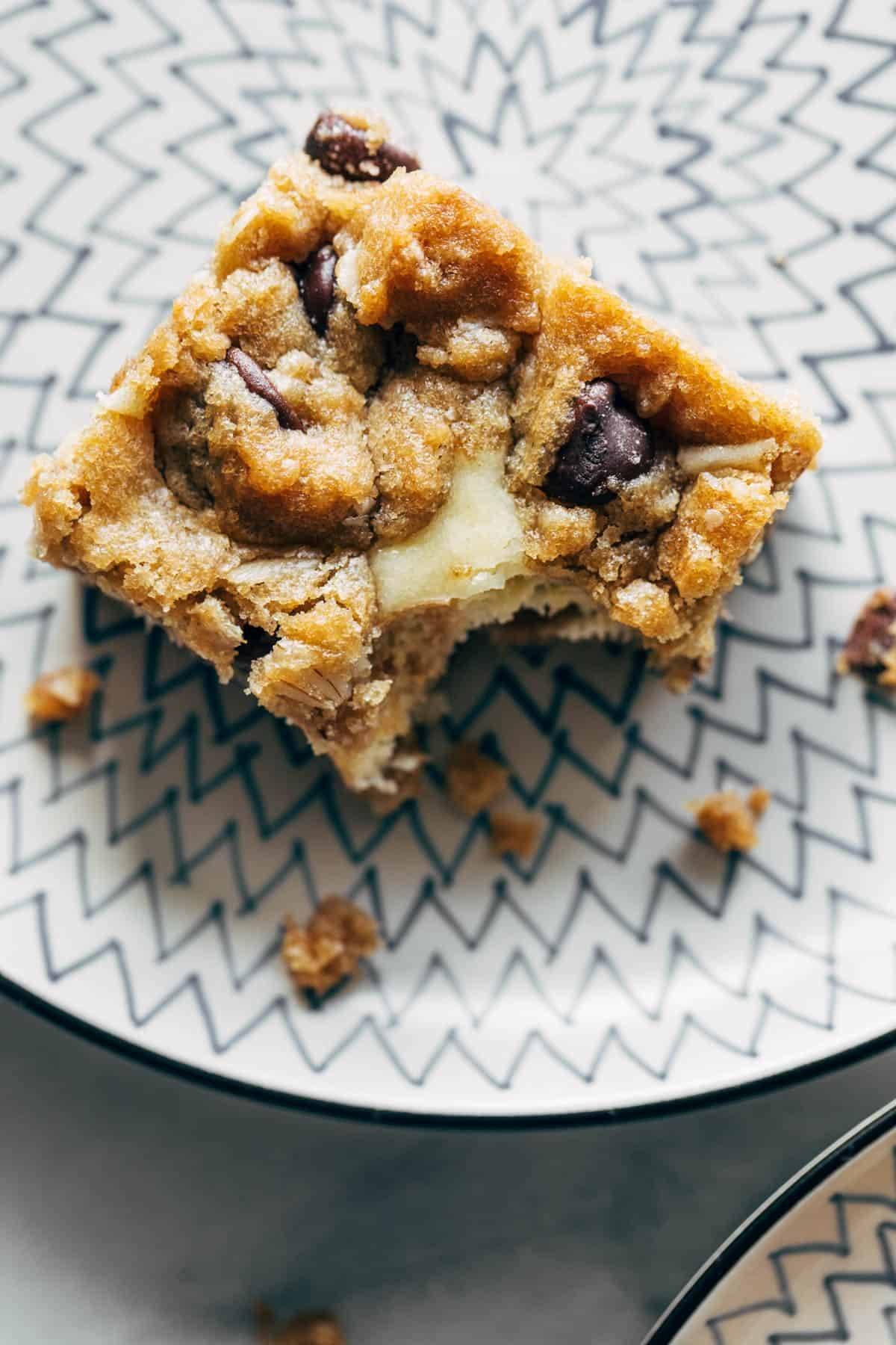 Peanut Butter Chocolate Chip Cookie Cheesecake Bars on a plate.