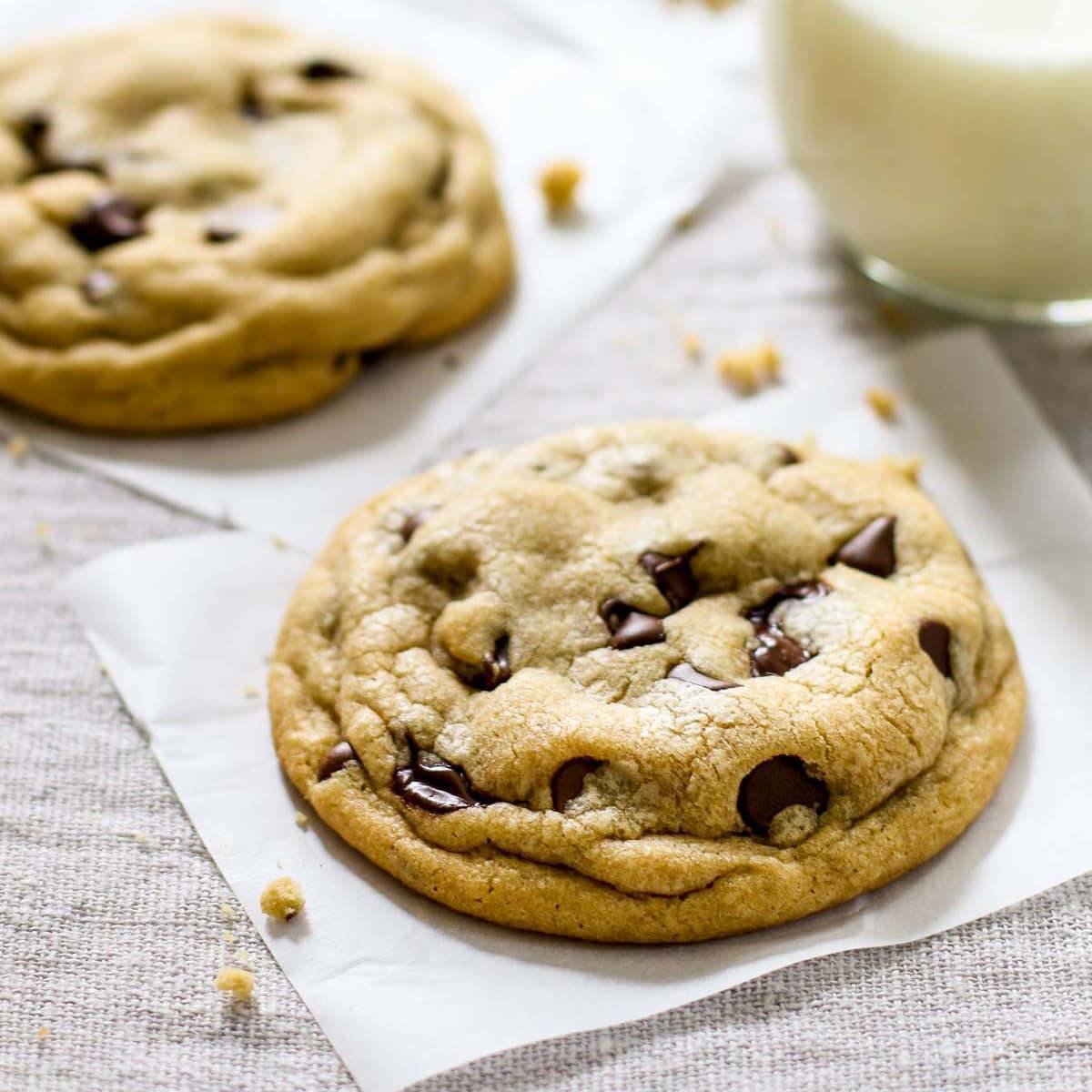 Soft chocolate chip cookies on parchment paper.