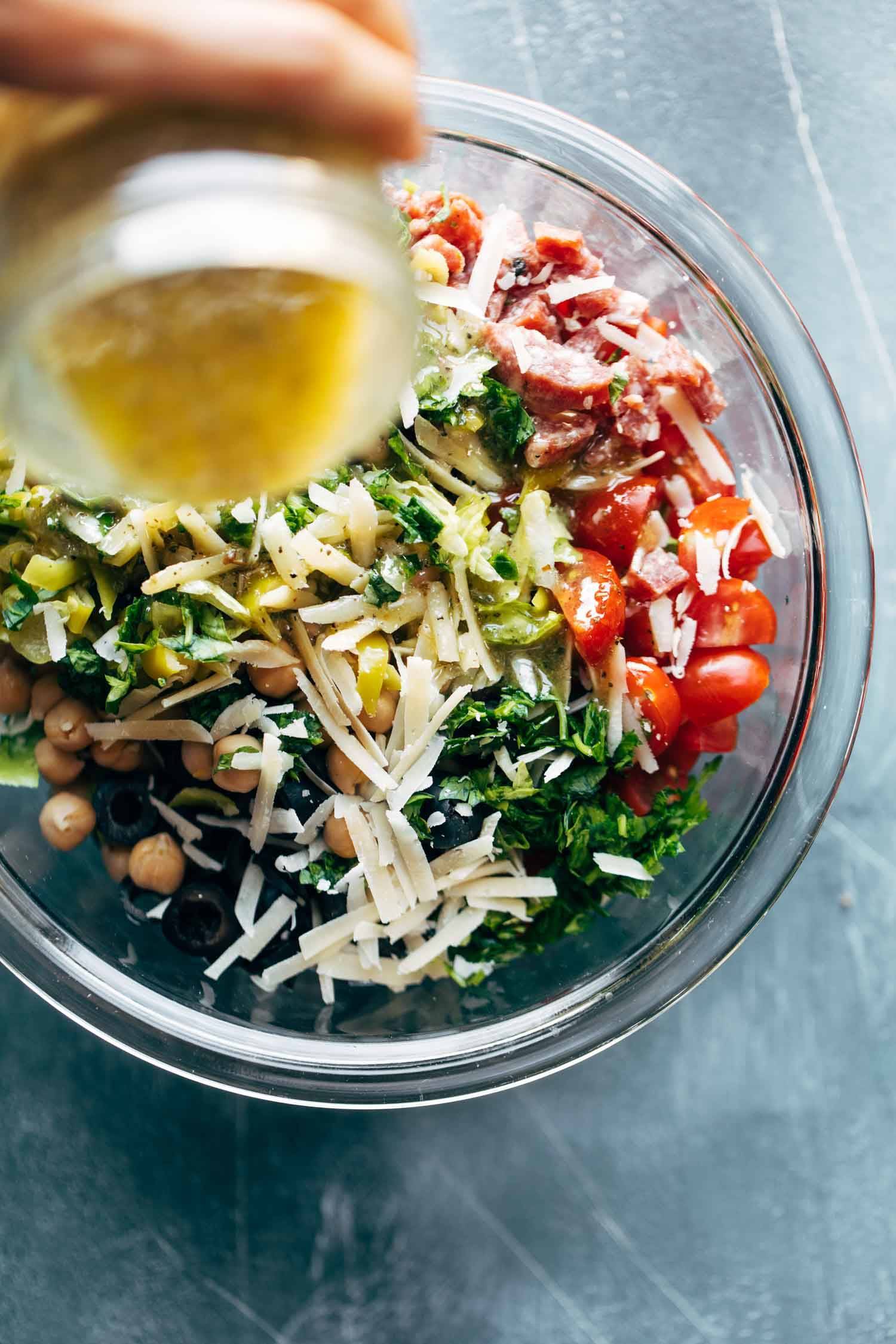 Chopped Salad Pizza ingredients in a bowl with drizzle