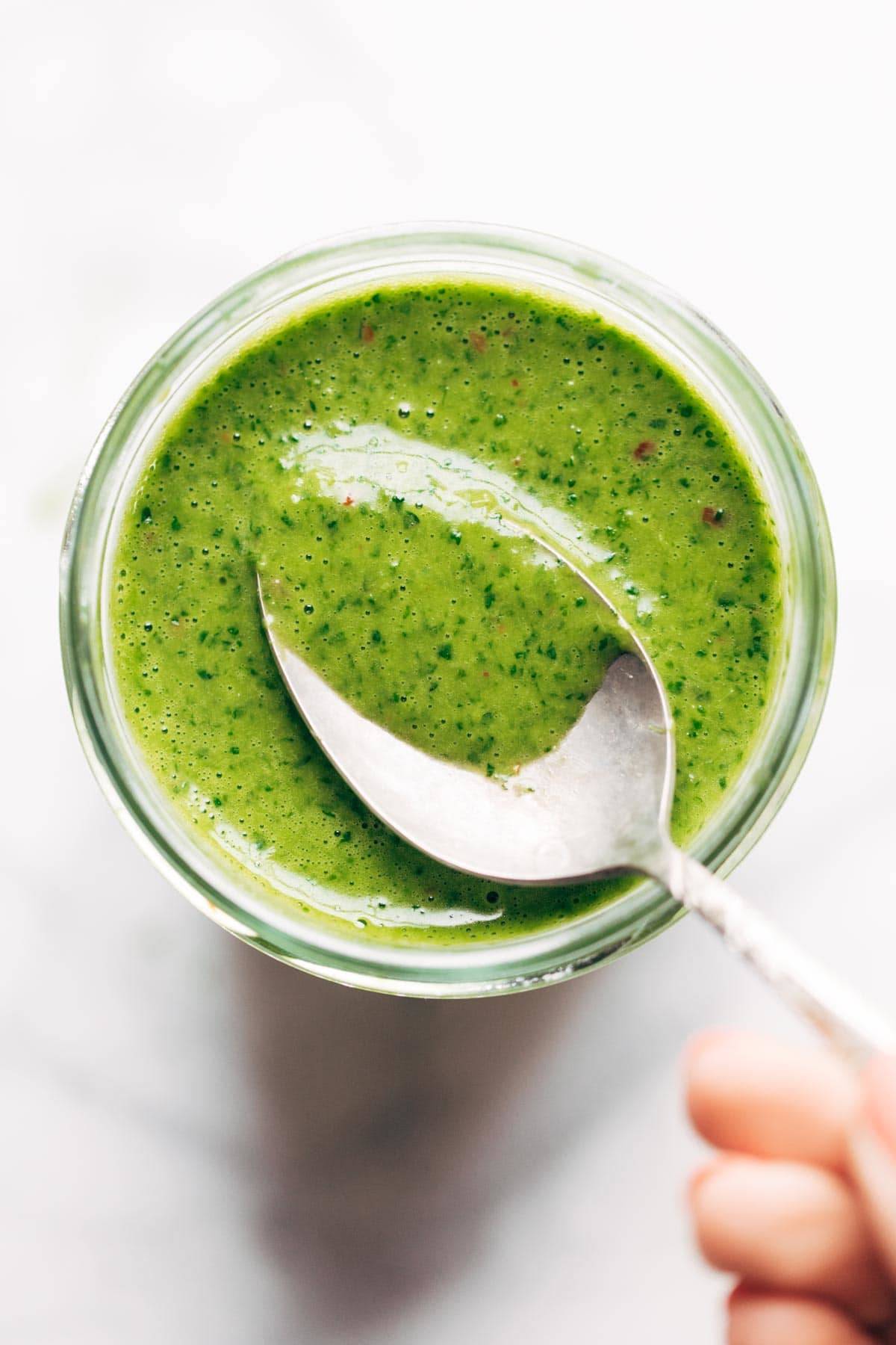 Cilantro Vinaigrette in a jar with a spoon.