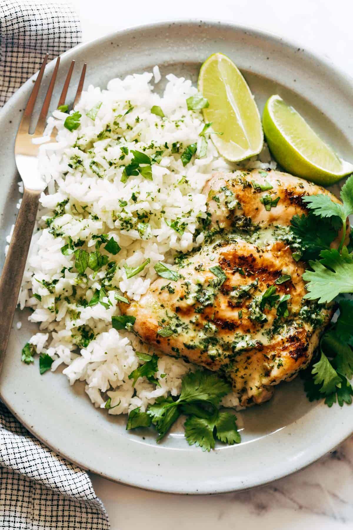 Coconut Lime Grilled Chicken with rice and cilantro on a plate.
