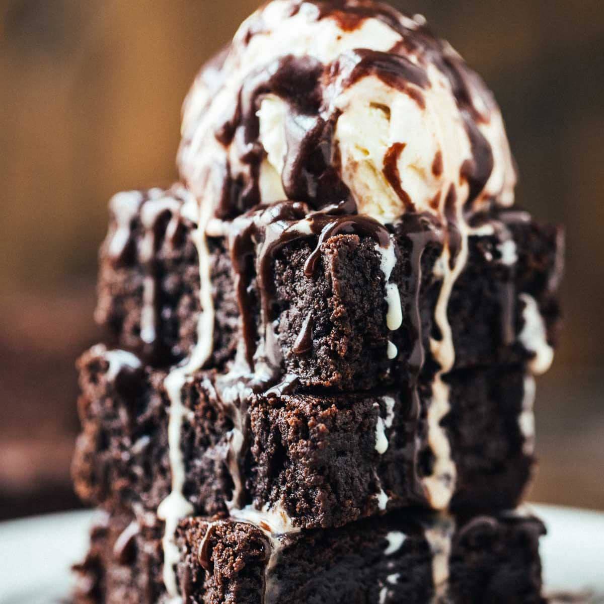 Extra Fudgy Coconut Oil Brownies on a plate with ice cream.