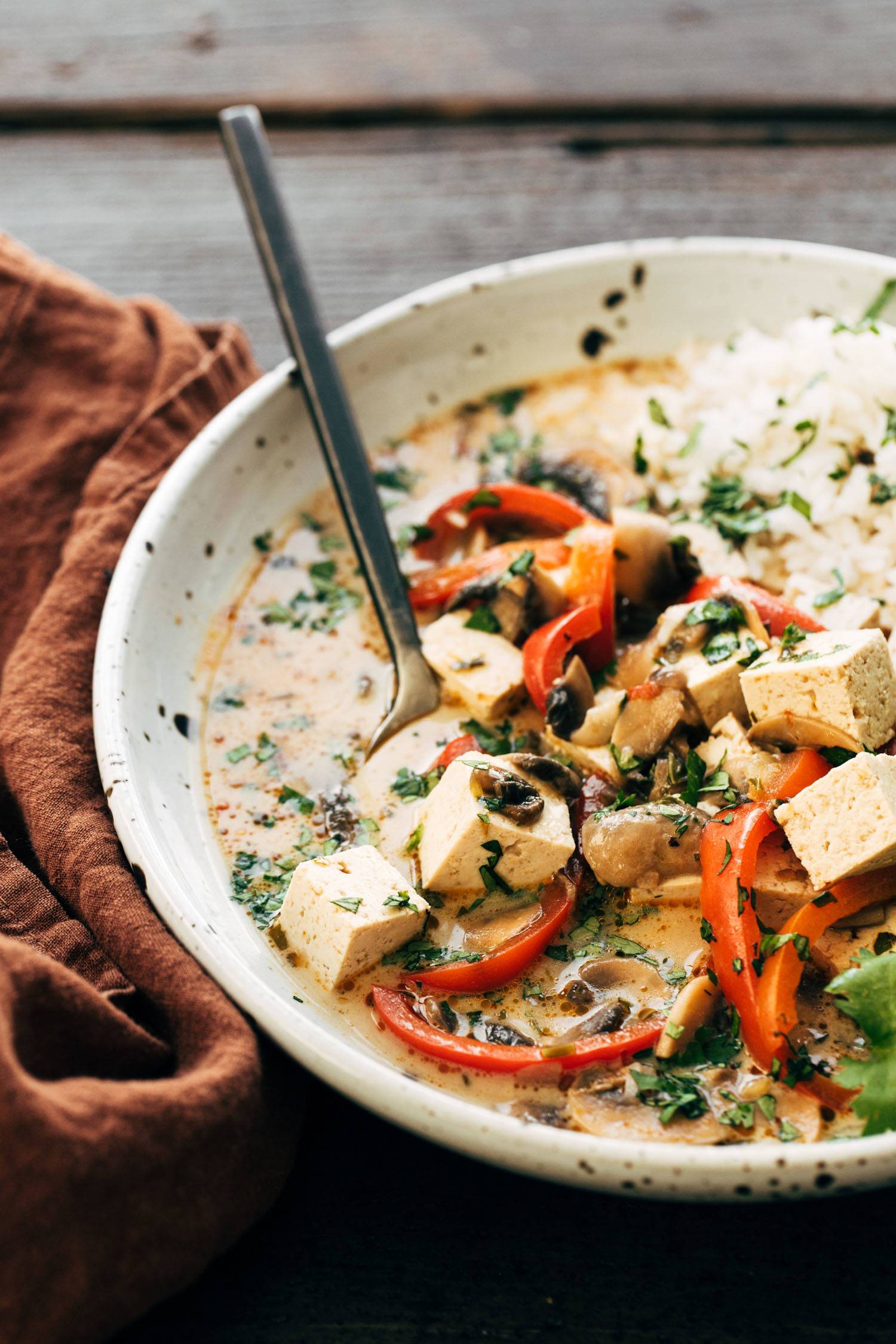 Thai Coconut Soup in a bowl with tofu and rice. 