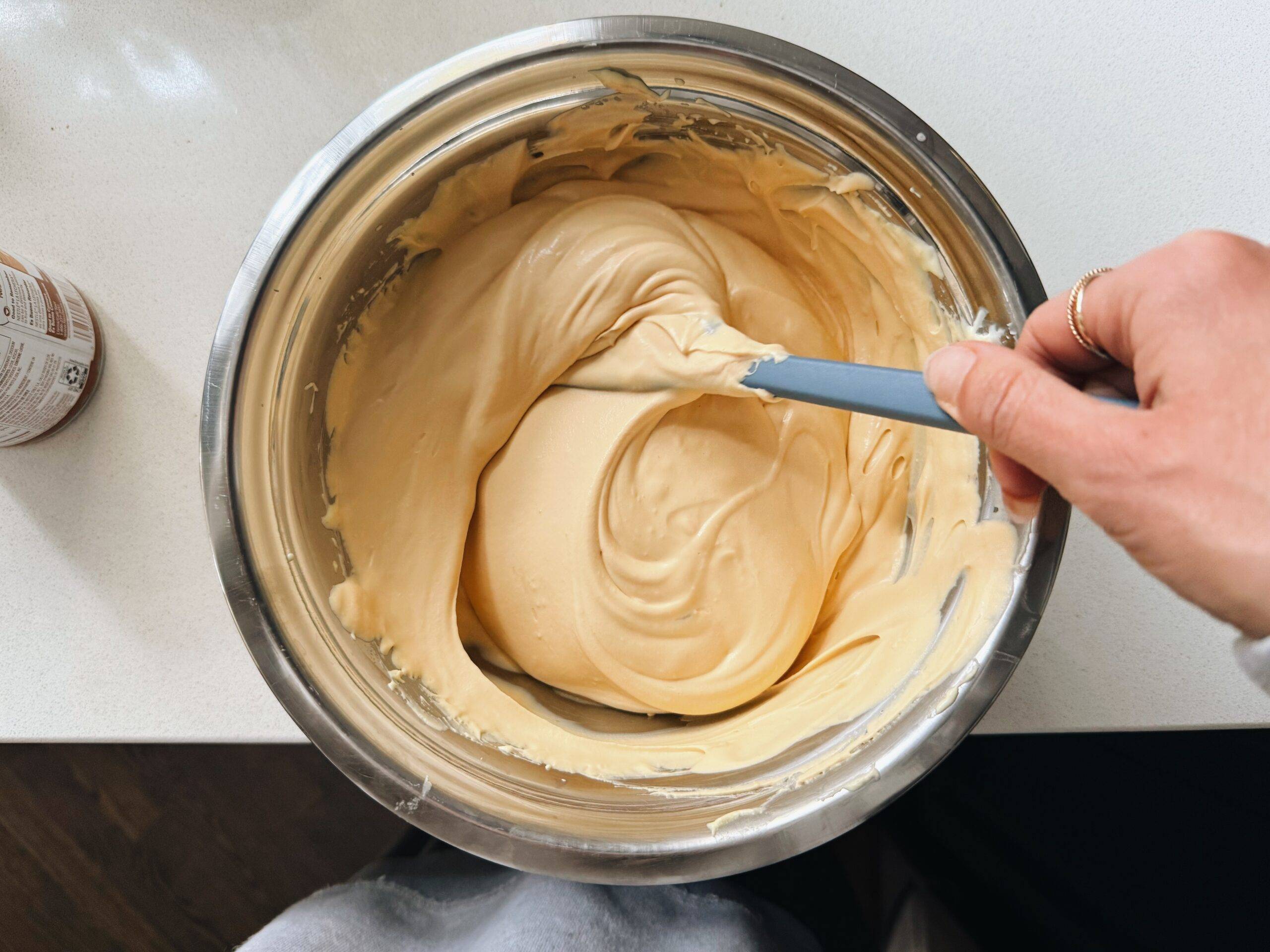 Mixing the two bowls together for tiramisu.