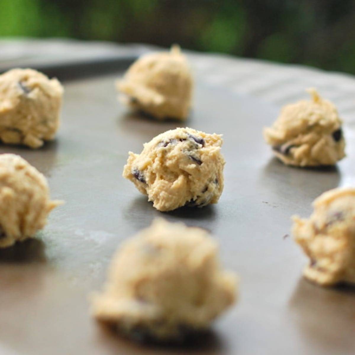 New York Times Chocolate Chip Cookie dough balls on a pan.