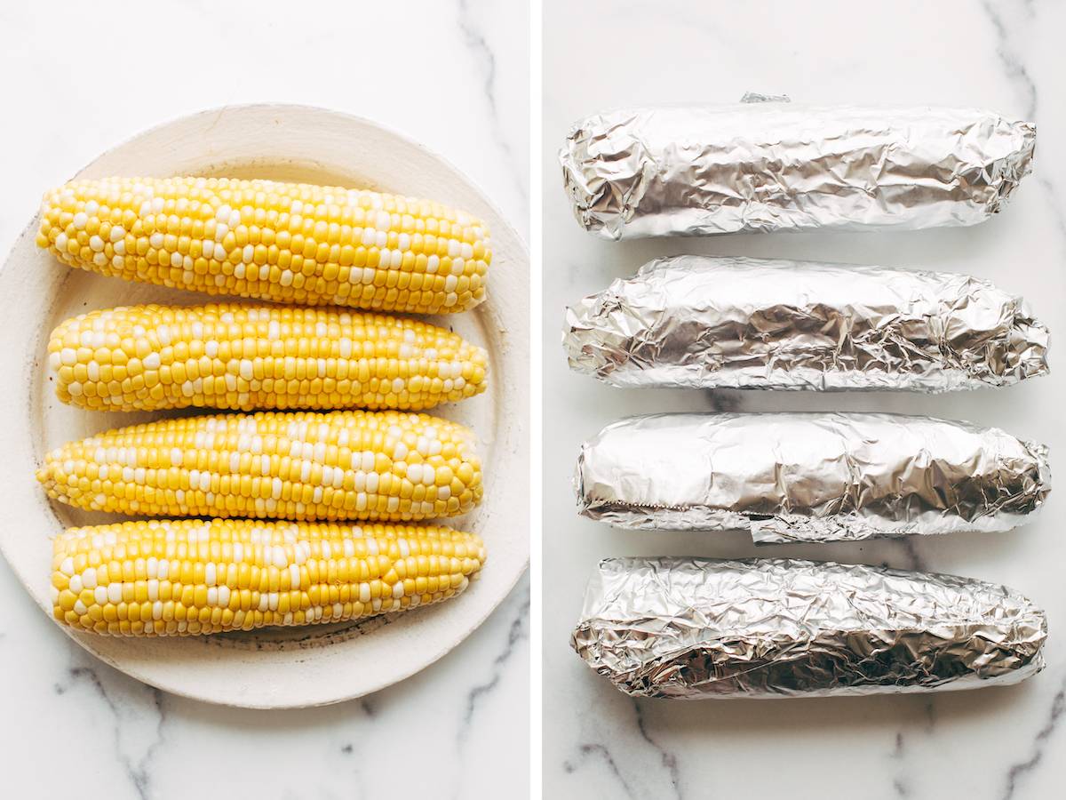 Four ears of corn on a plate and wrapped in foil.