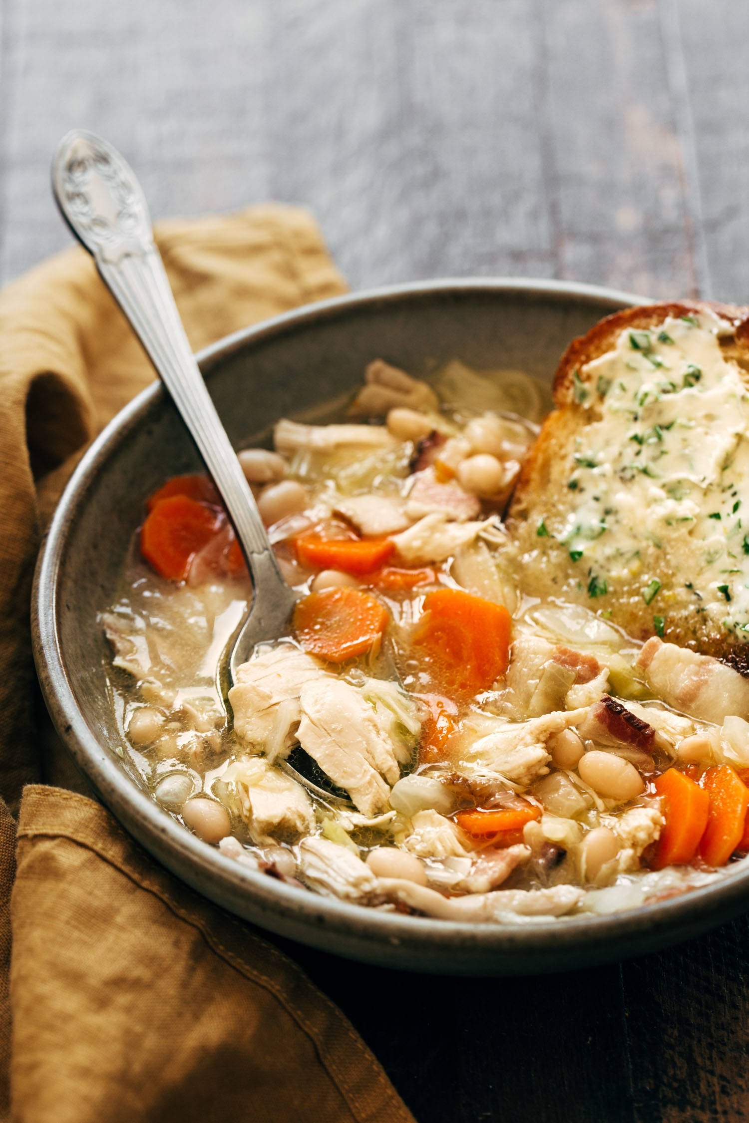 Chicken stew in a bowl with a spoon.