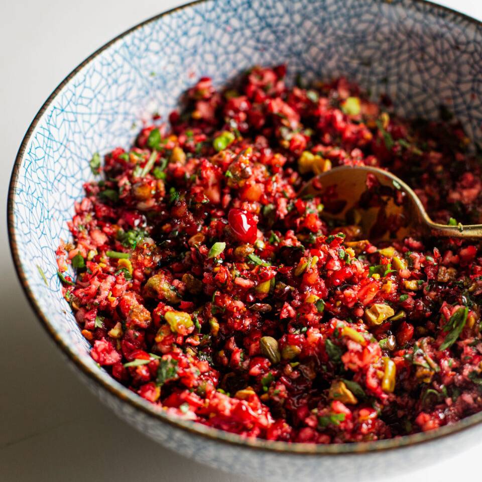 Cranberry salsa in a bowl with a spoon.