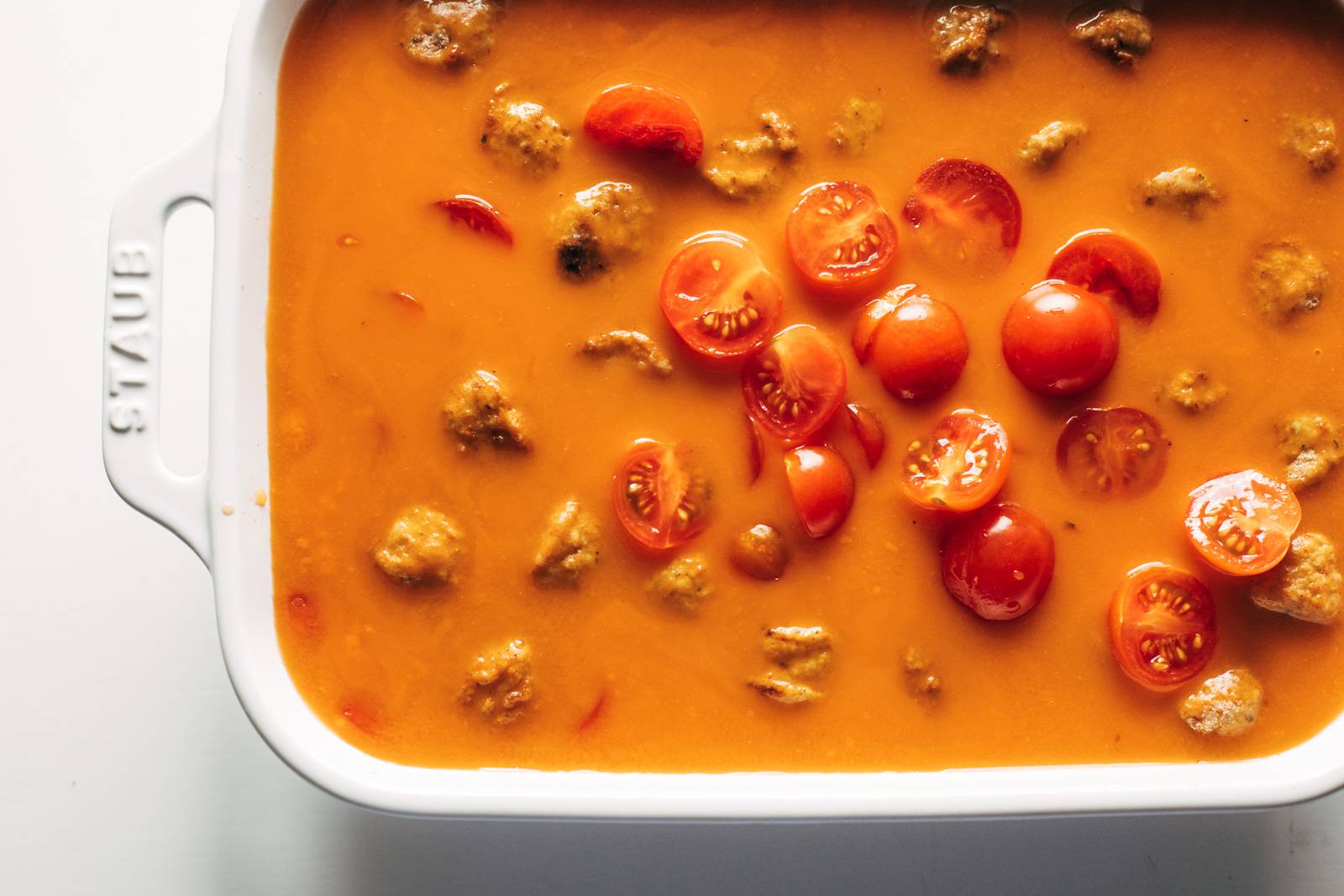 Tomatoes, orzo, meatballs, and tomato soup get mixed into 9x13 pan.