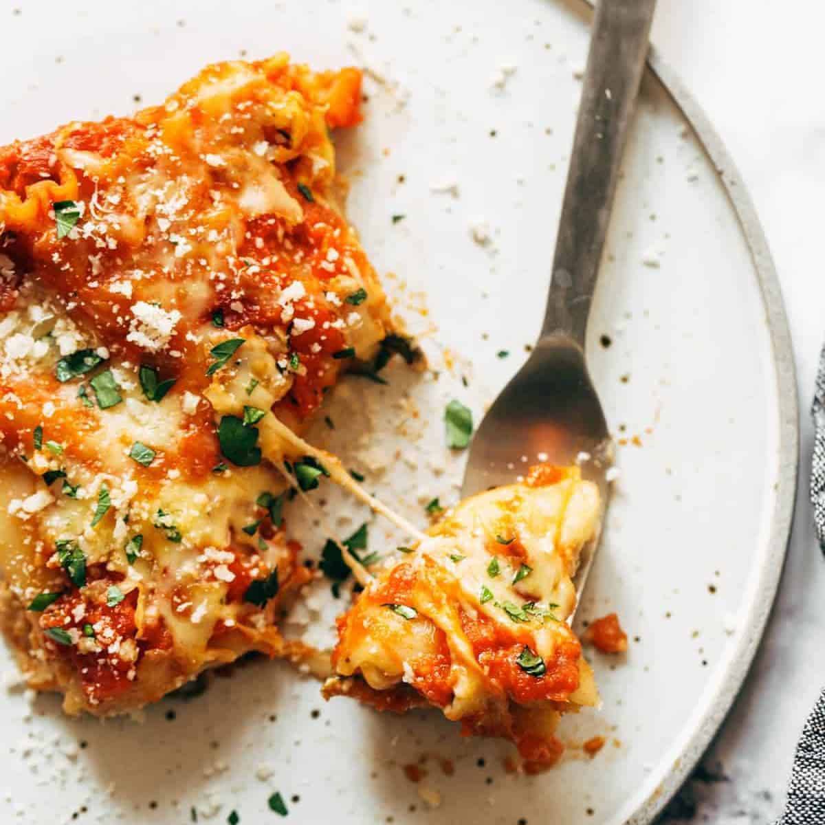 Creamy Tomato Lasagna Florentine on a plate with a fork.