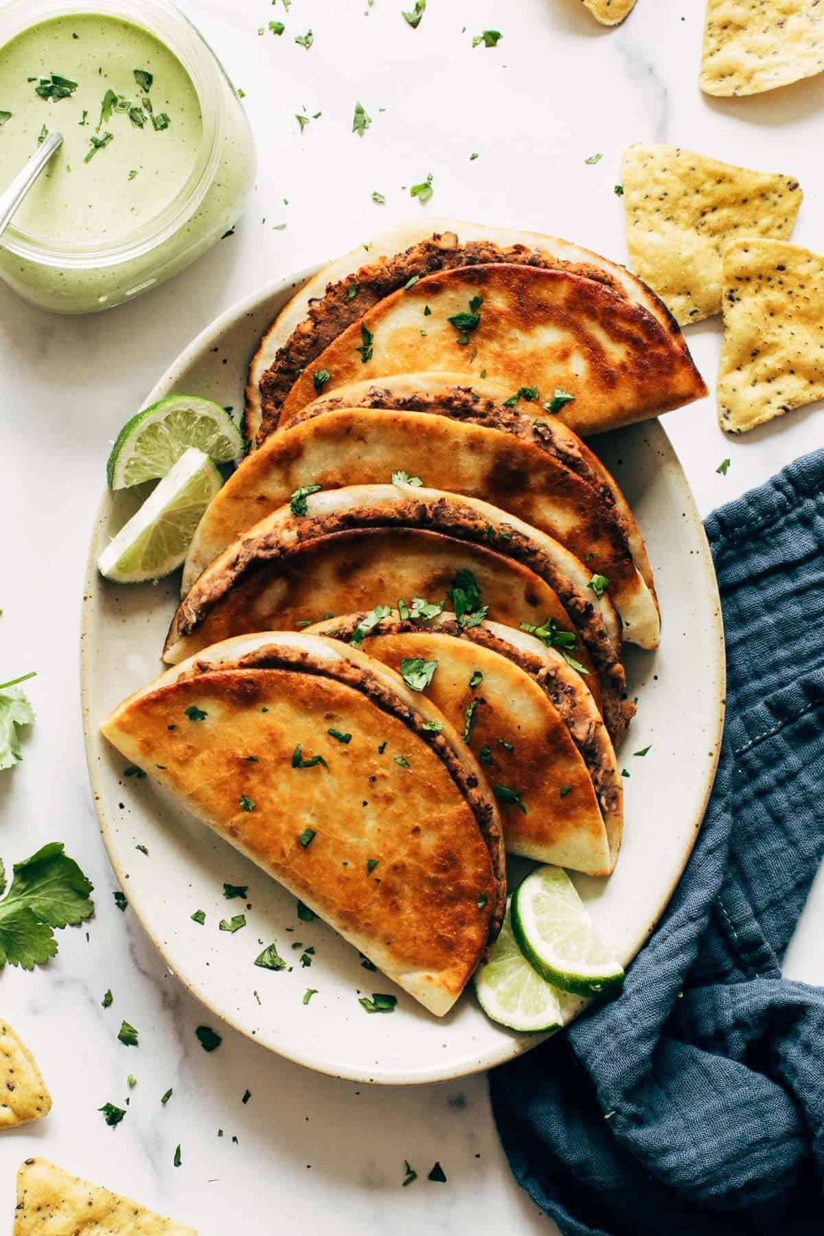 Crispy black bean tacos on a plate.