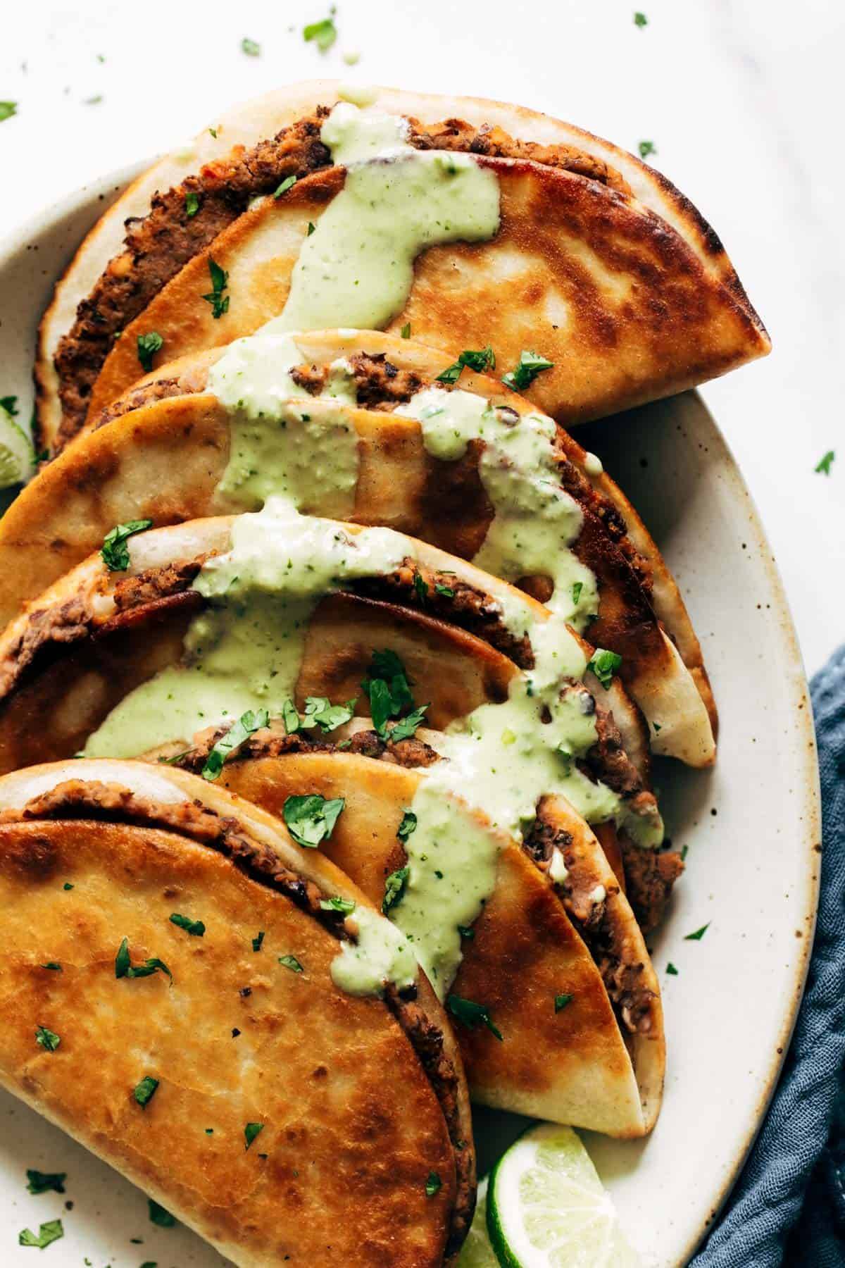 Crispy Black Bean Tacos drizzled with Cilantro Lime Sauce