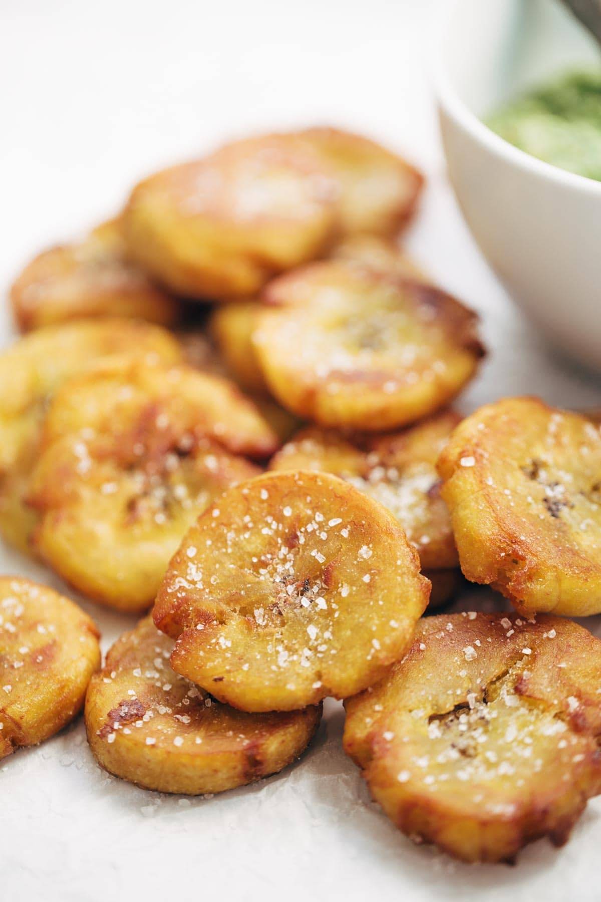 Crispy Salted Tostones - super easy recipe for golden brown bites of perfection with just one ingredient: PLANTAINS! video demo in the post. | pinchofyum.com