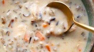 Wild rice soup in a bowl with a spoon.