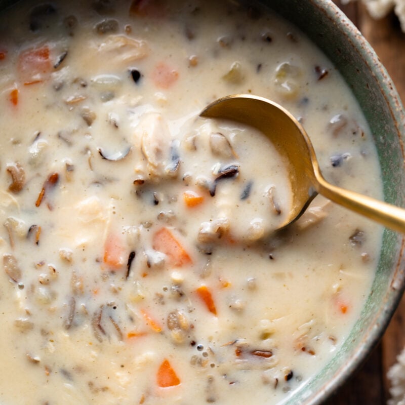 Wild rice soup in a bowl with a spoon.