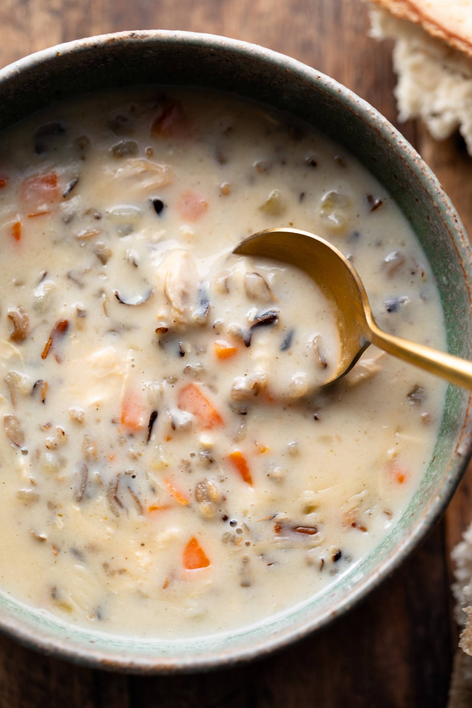 Chicken wild rice soup in a bowl with a spoon.