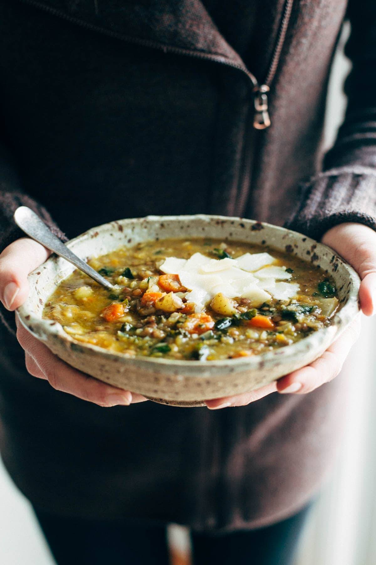 Lentil soup held in bowl.