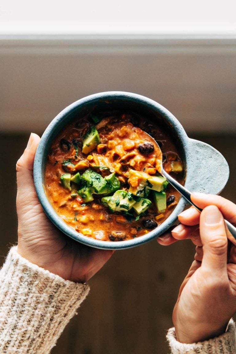 Queso chicken chili in a bowl with a spoon.