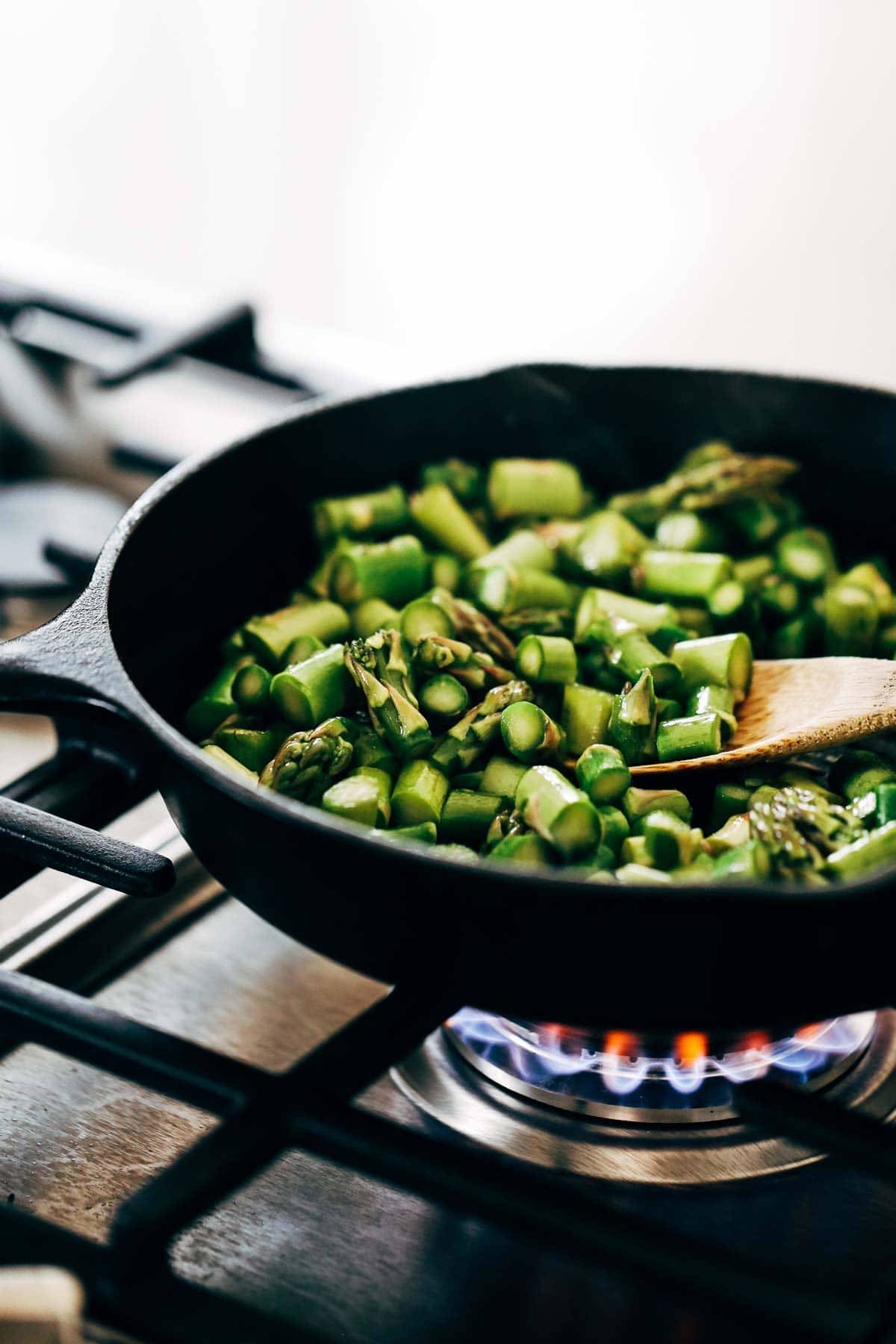 Asparagus in a skillet over the stove.