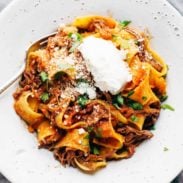 Slow Cooker Beef Ragu with Pappardelle in a bowl with ricotta.
