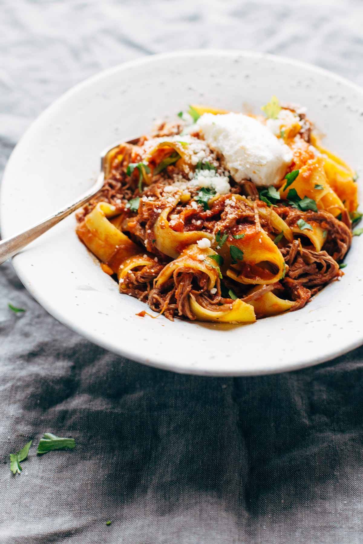 Beef ragu with pappardelle in a bowl with a fork. 