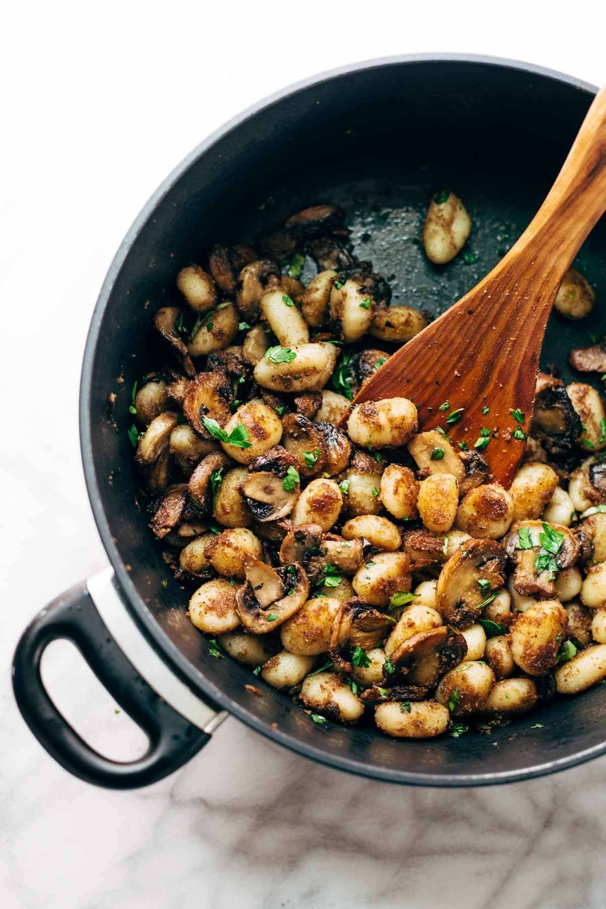 Mushroom Gnocchi with Walnut Pesto and Arugula - a vegetarian bowl that's made with familiar ingredients. Comes together in 30 minutes or less! | pinchofyum.com