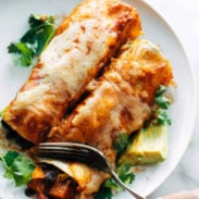 Veggie enchiladas on a plate with a fork