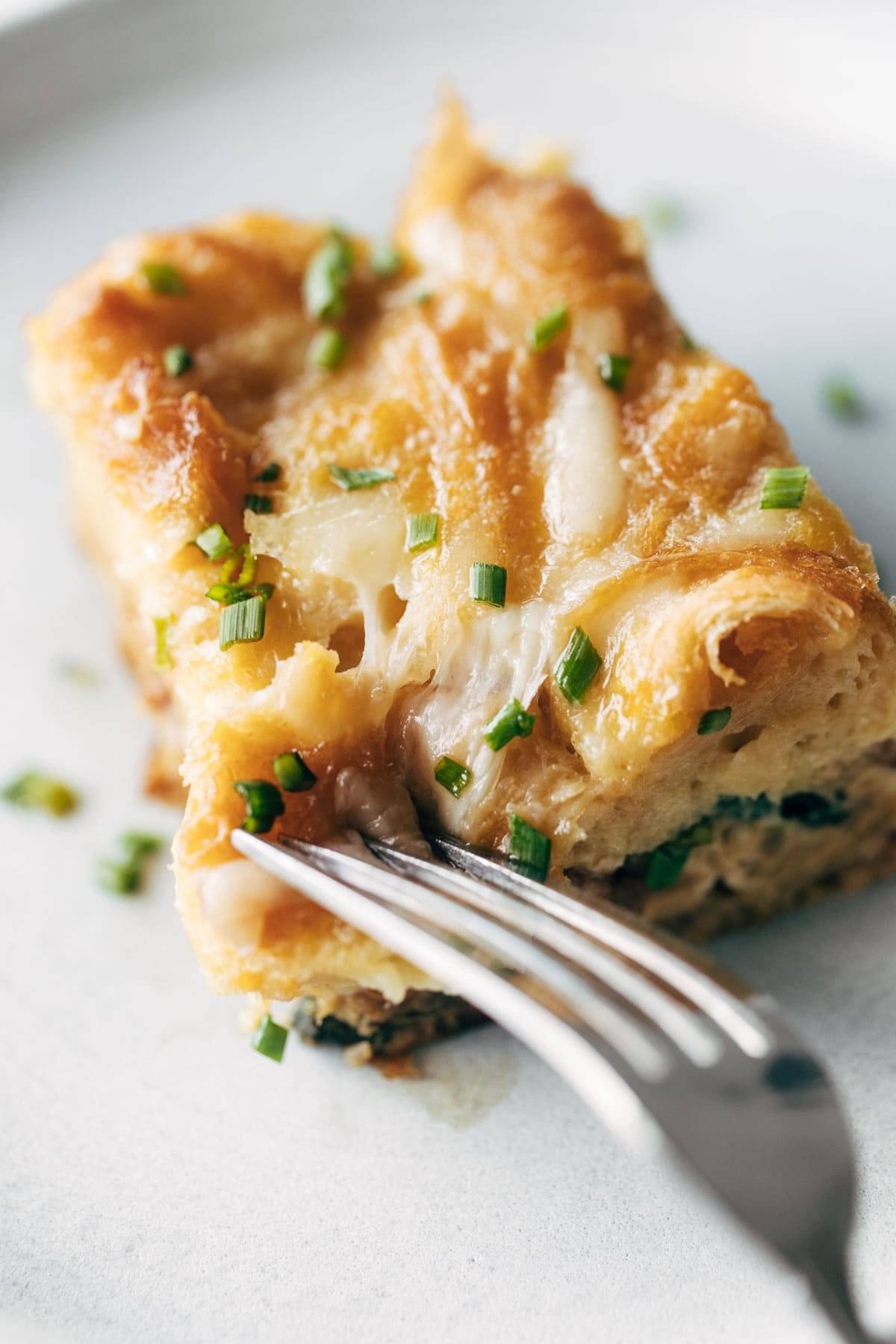 Slice of egg and croissant brunch bake.