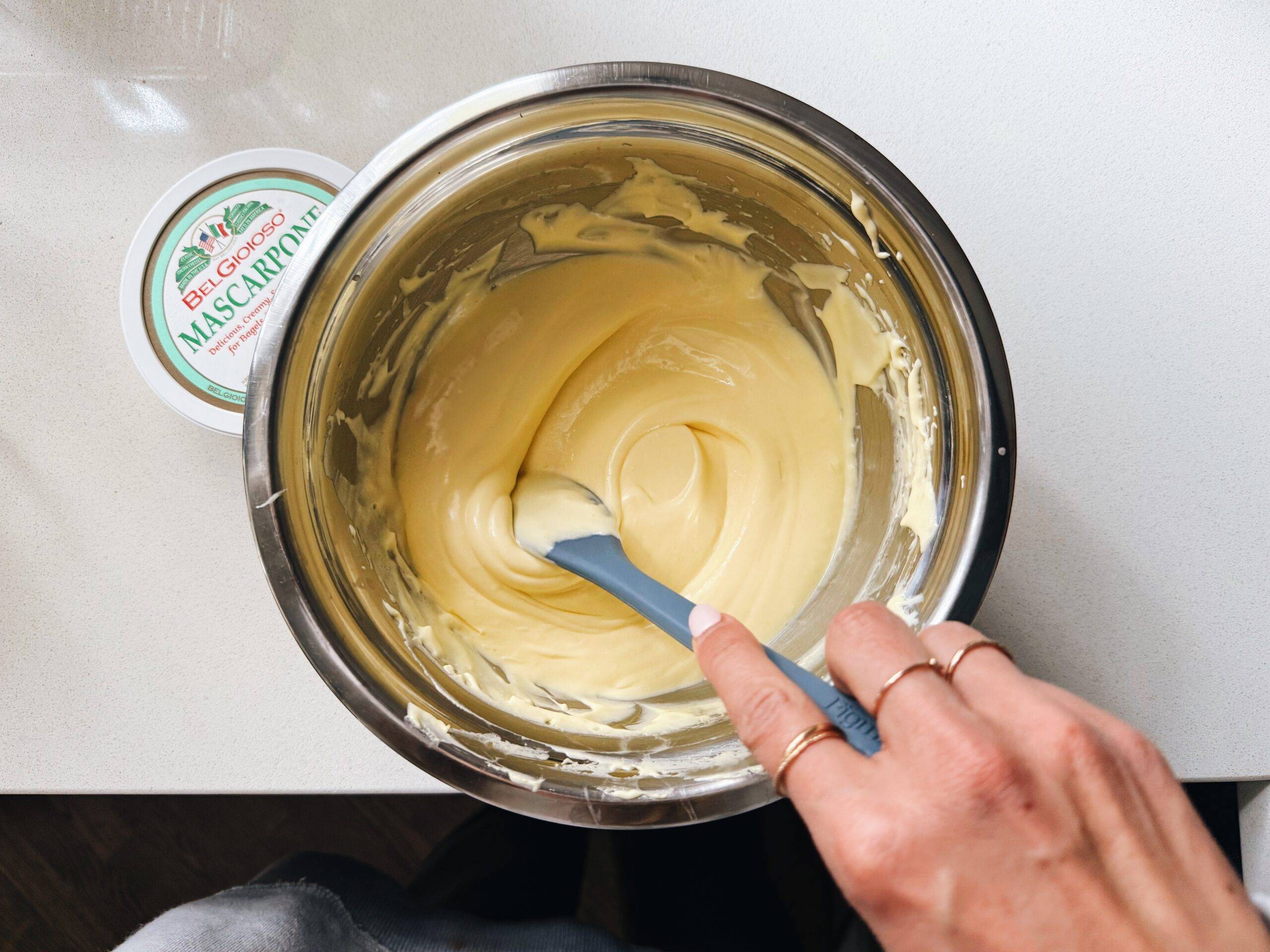 Mixing mascarpone, egg yolks, and sugar.