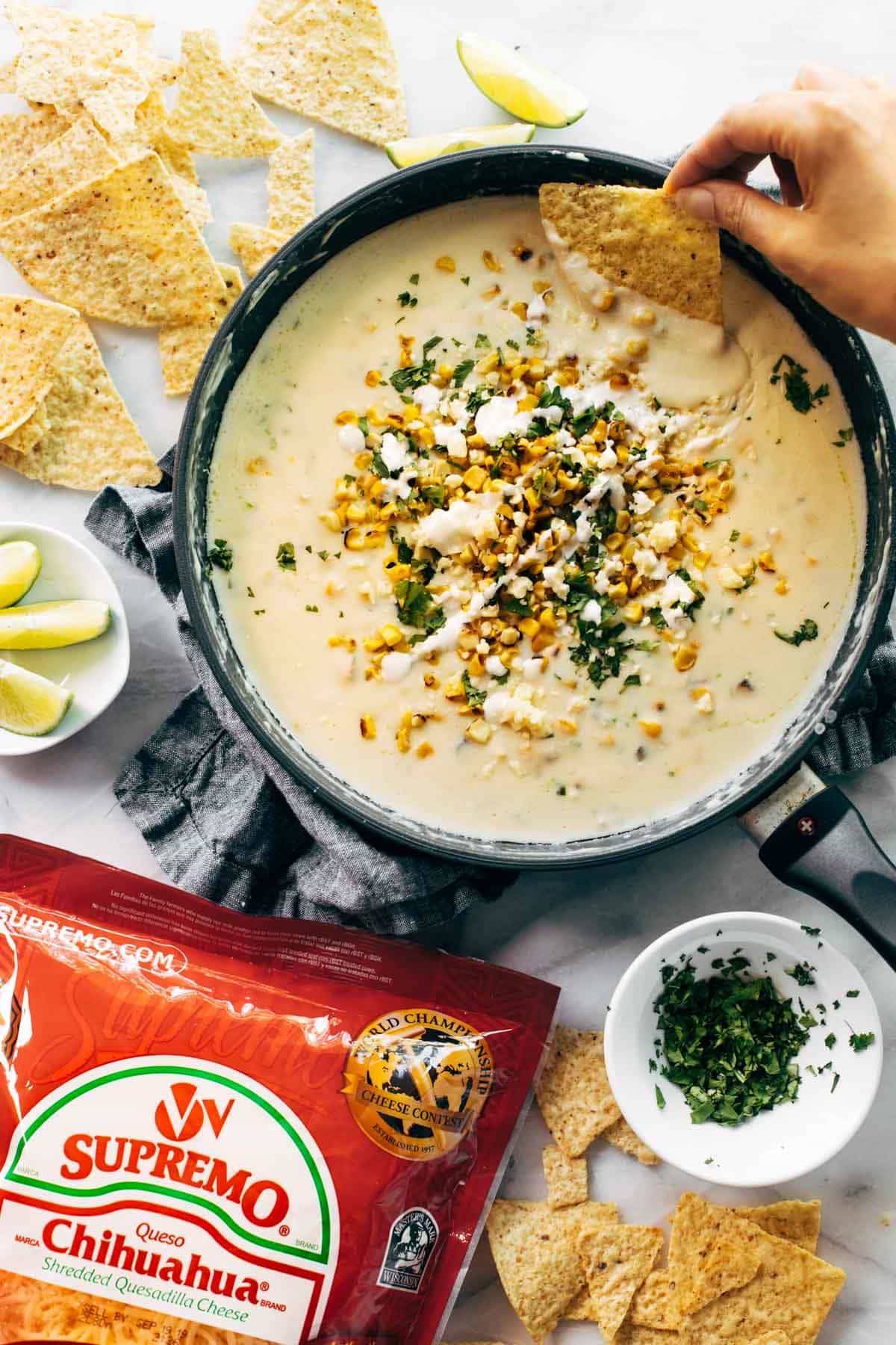 Elote queso in a pan with chips.
