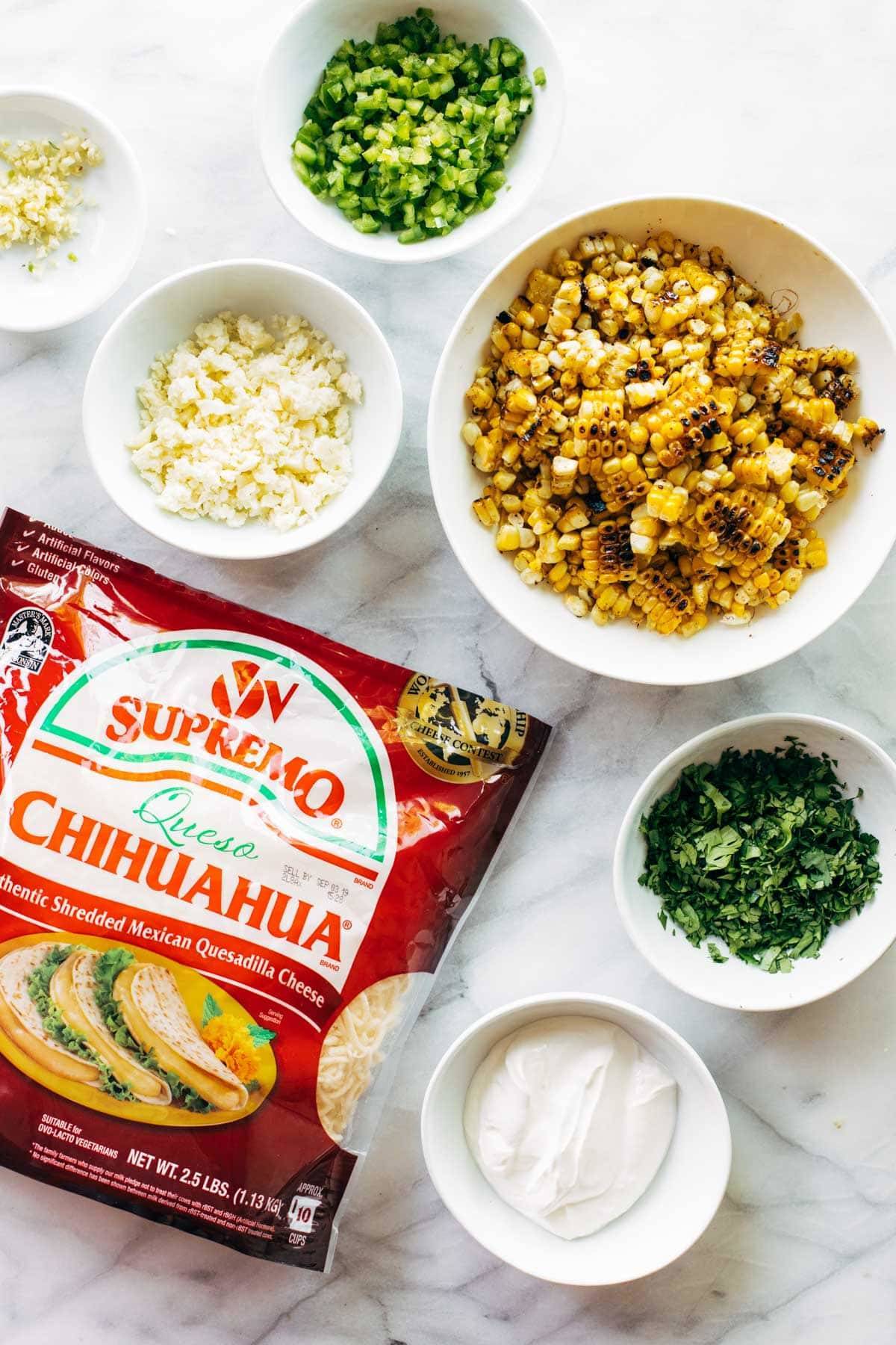 Ingredients in bowls for elote queso.