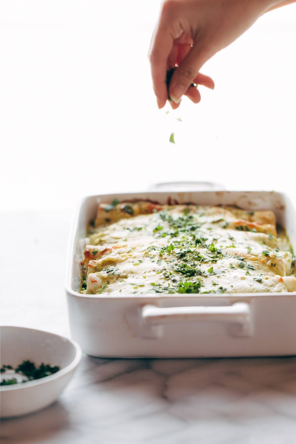 Enchiladas Verdes, with a simple homemade roasted tomatillo sauce that will make your tastebuds rock out. Plus chicken and cheese and tortillas. Super yum. | pinchofyum.com
