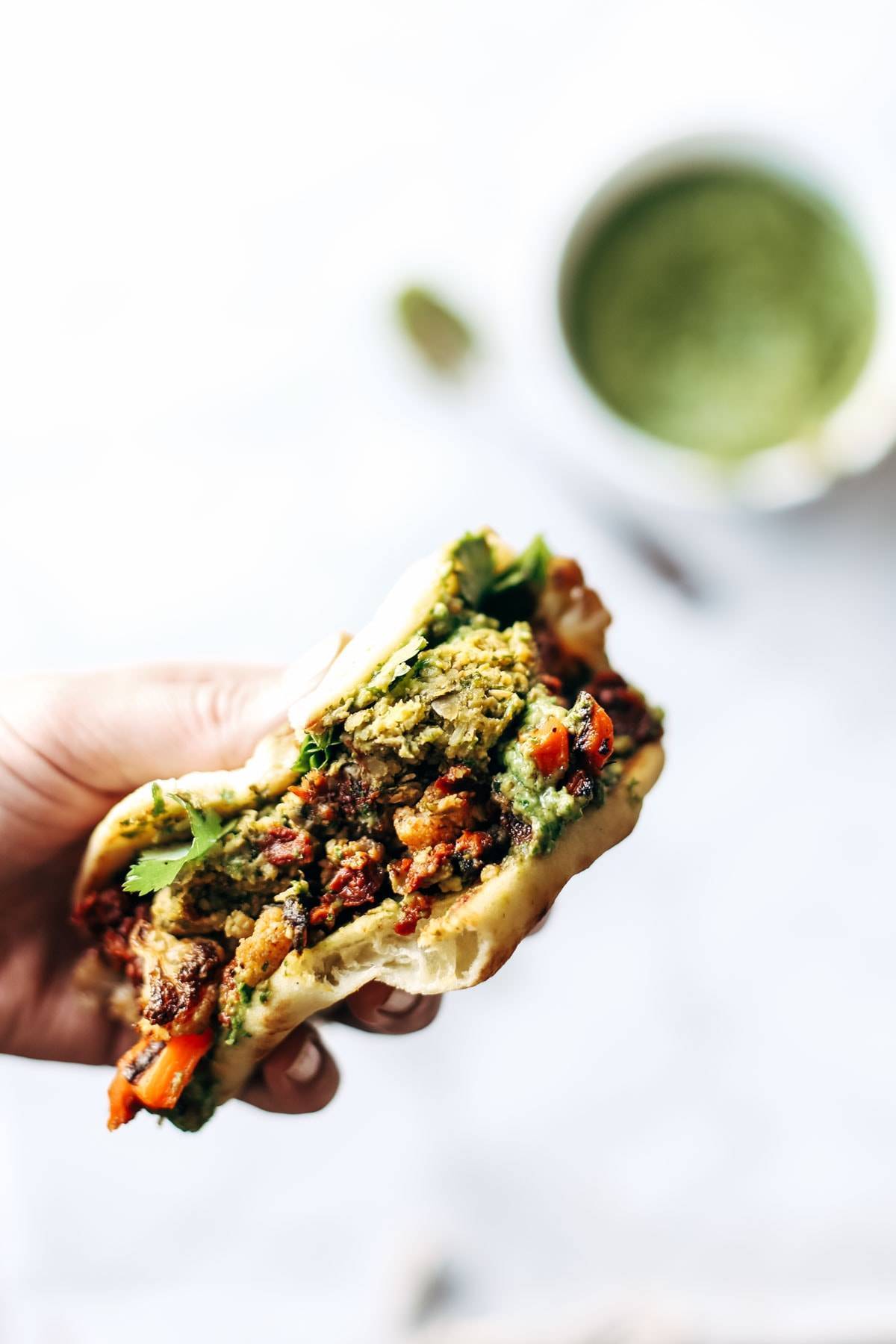 Naan-wich: 5 ingredient falafel, roasted veggies, and avocado sauce stuffed between pillowy garlic naan. Best sandwich recipe I've ever made. | pinchofyum.com