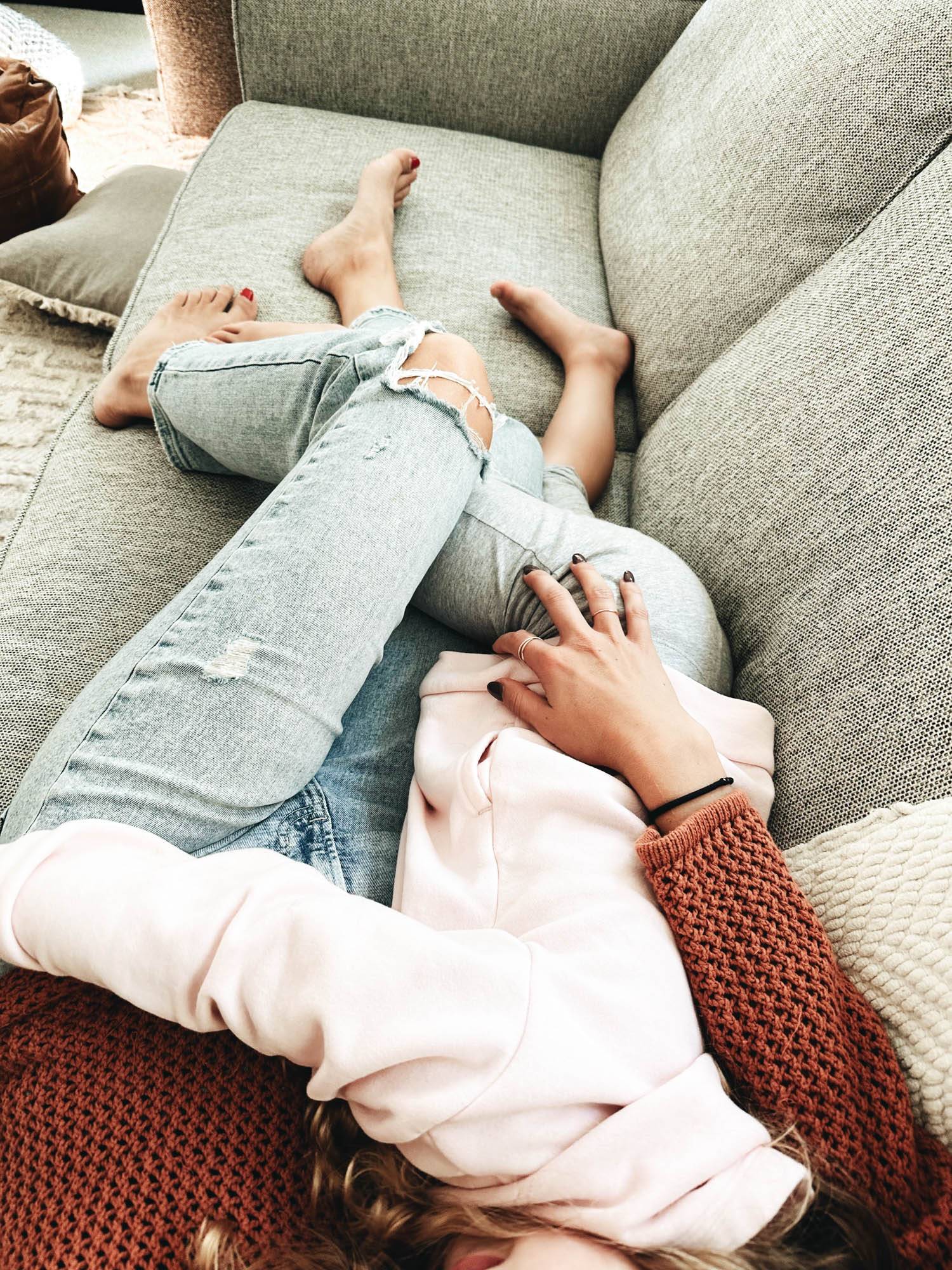 Mom holding daughter on couch