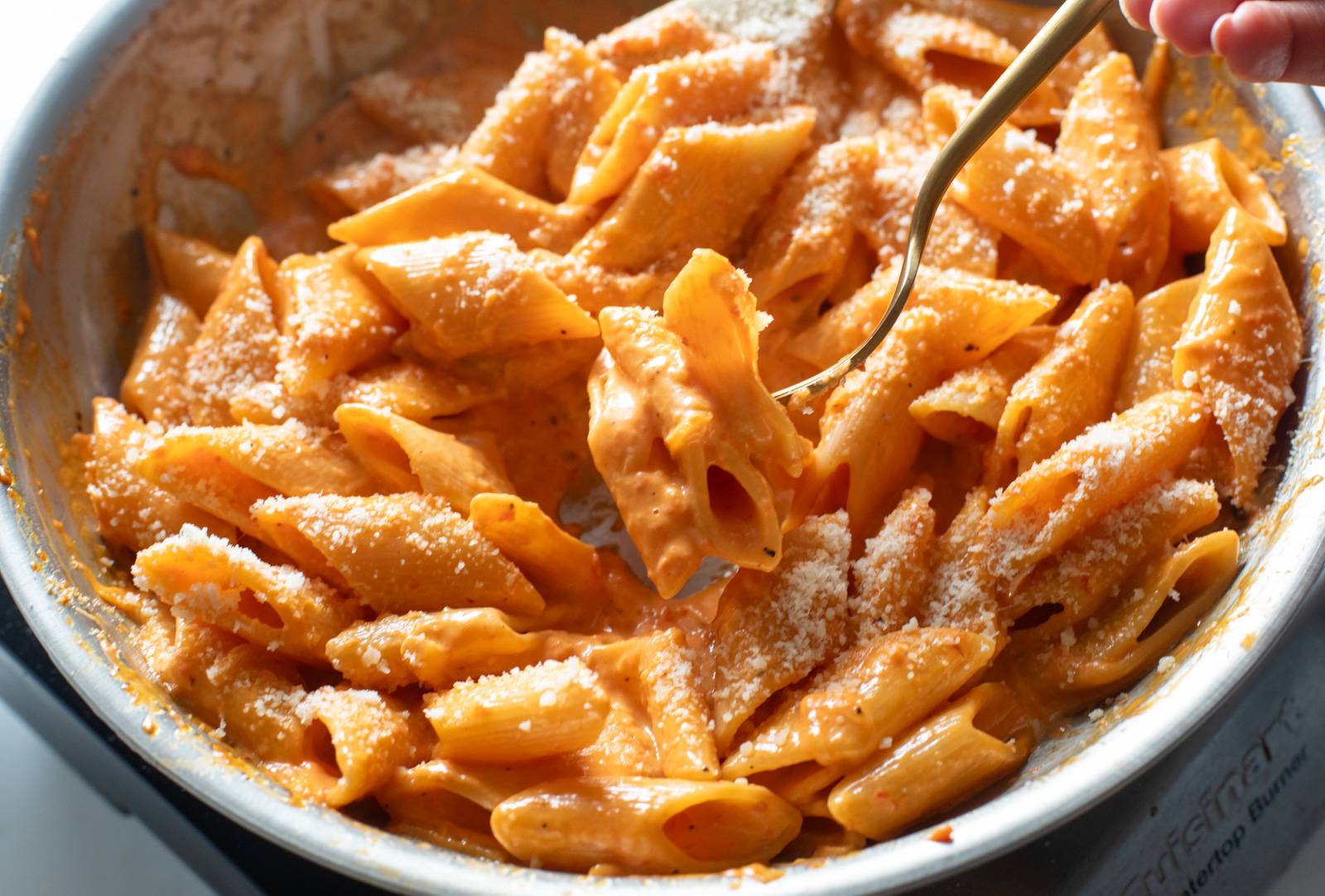 Finished red pepper pasta in a skillet.