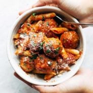 A bowl with pasta and meatballs.