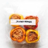Four stuffed peppers in a clear plastic bag.