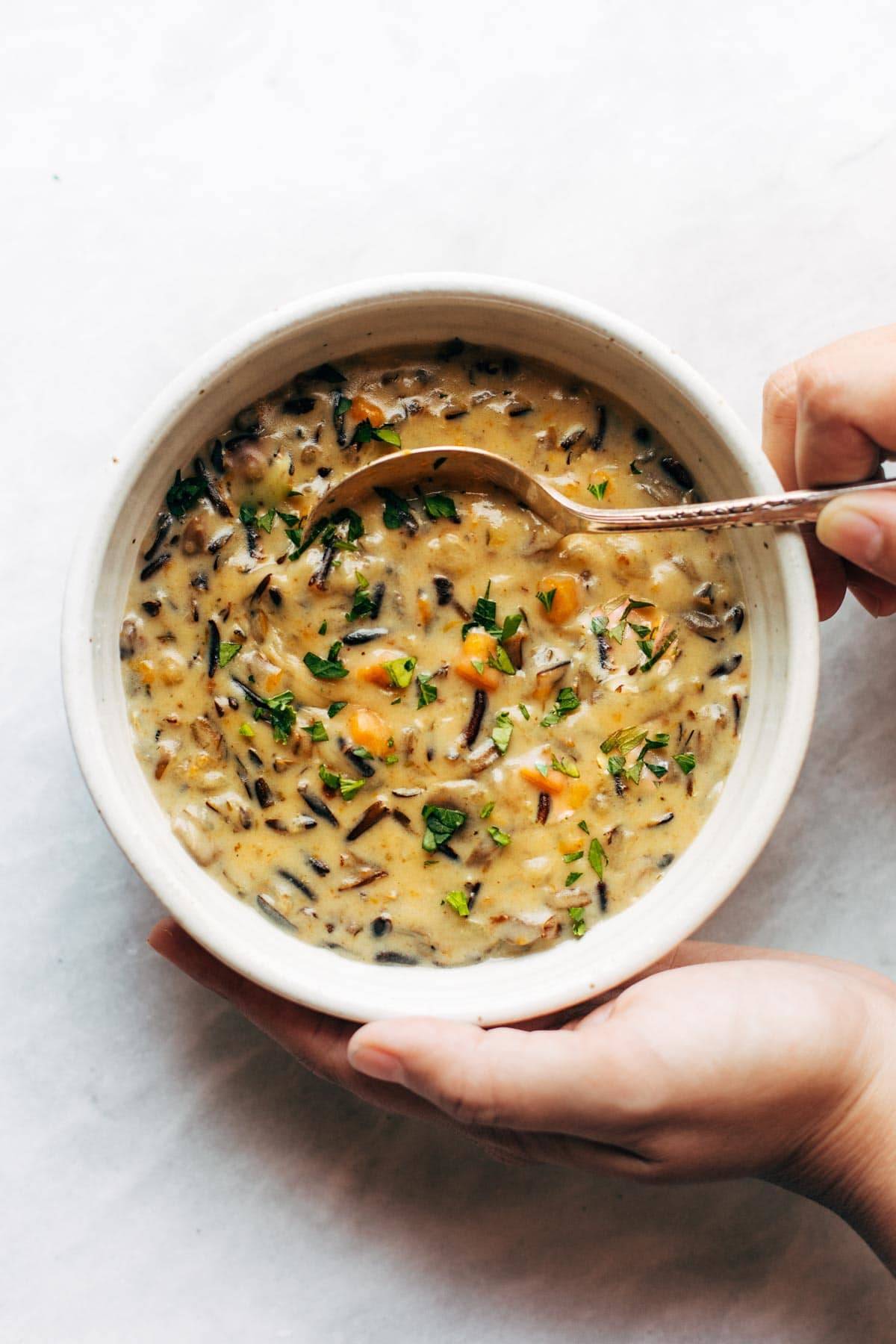 Wild rice soup in a bowl with a spoon.