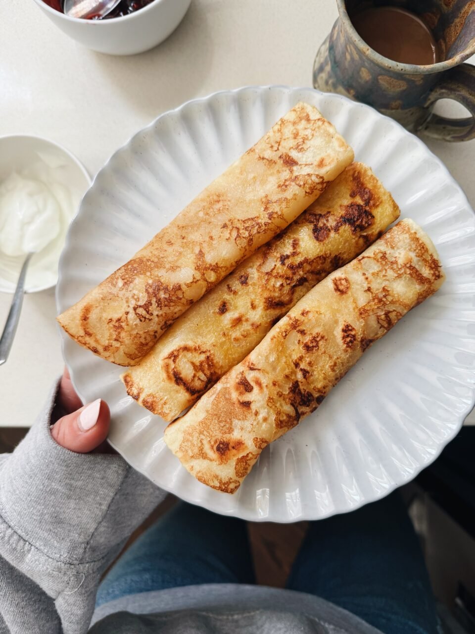 French toast crepes rolled on a plate.