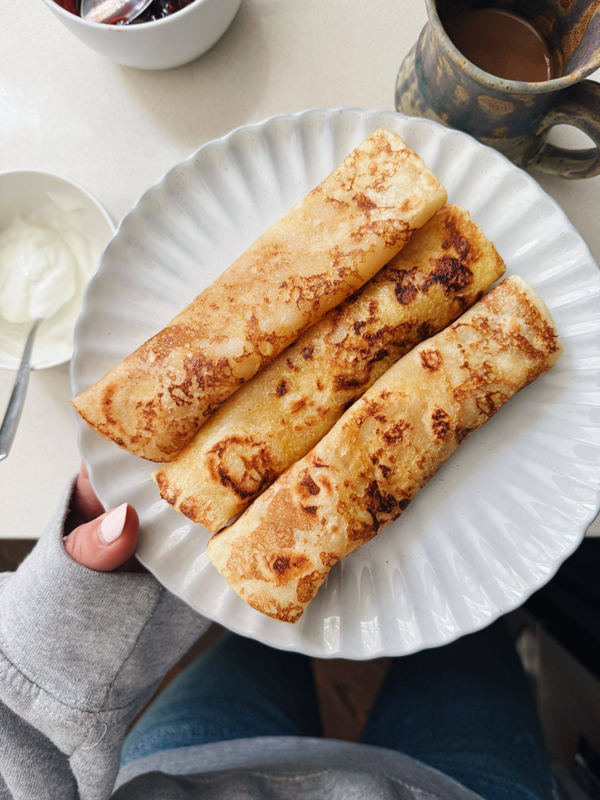 French toast crepes rolled on a plate.