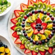 Fruit arranged on a fruit pizza.