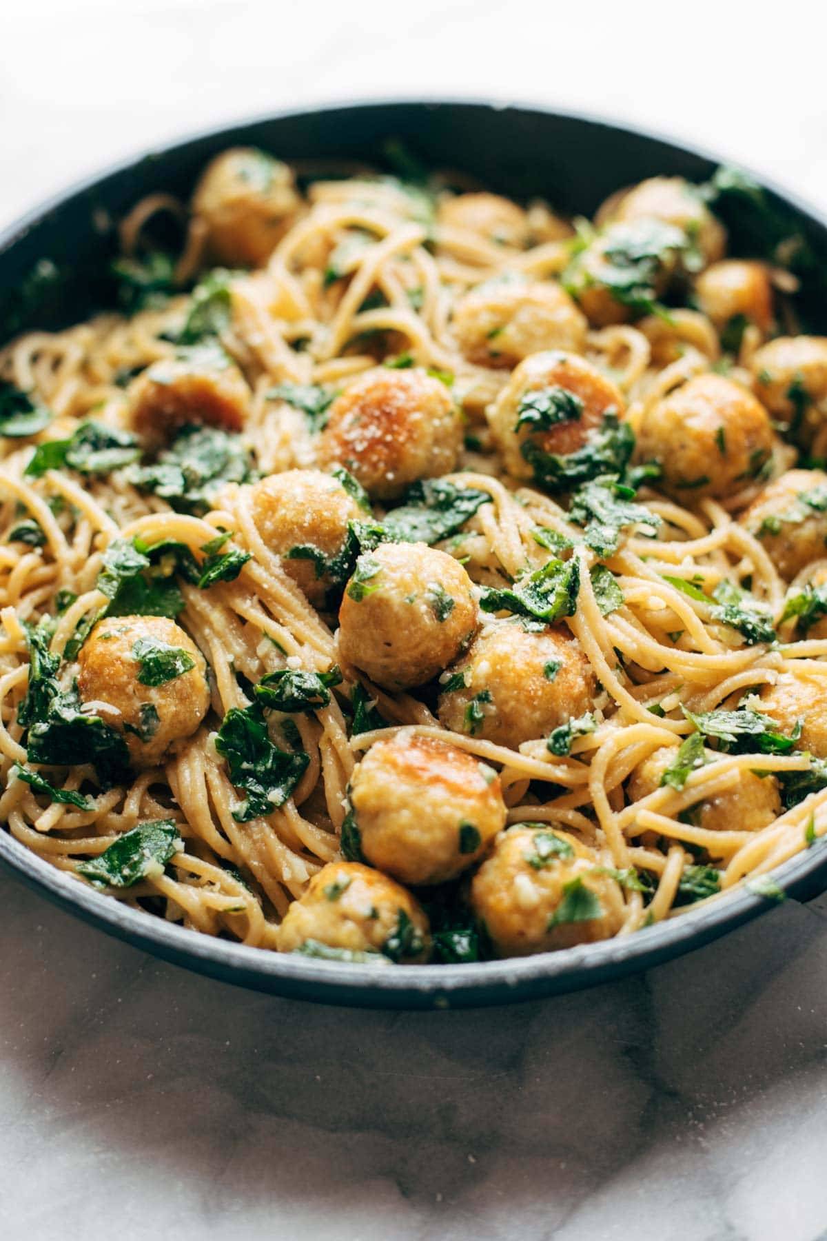 Garlic Herb Spaghetti with Baked Chicken Meatballs in a pan.