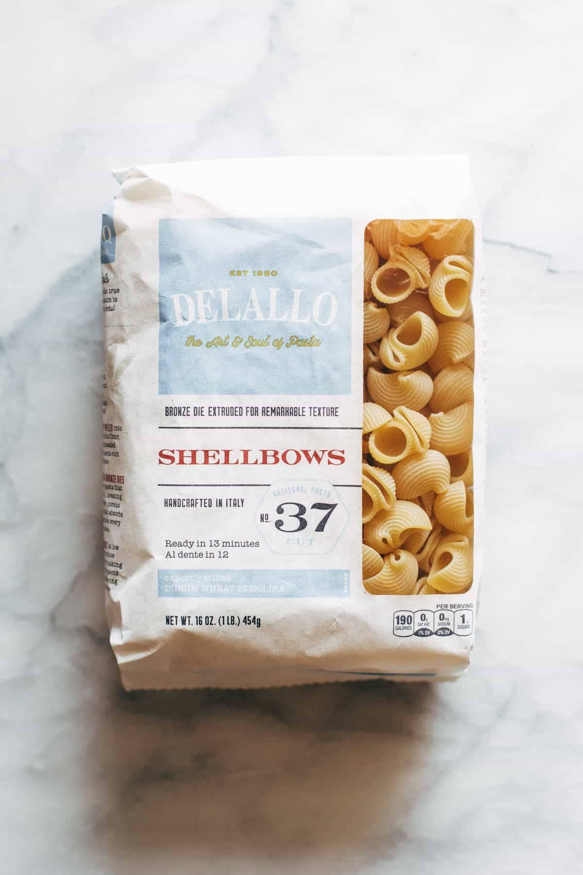 A white package of shell pasta.