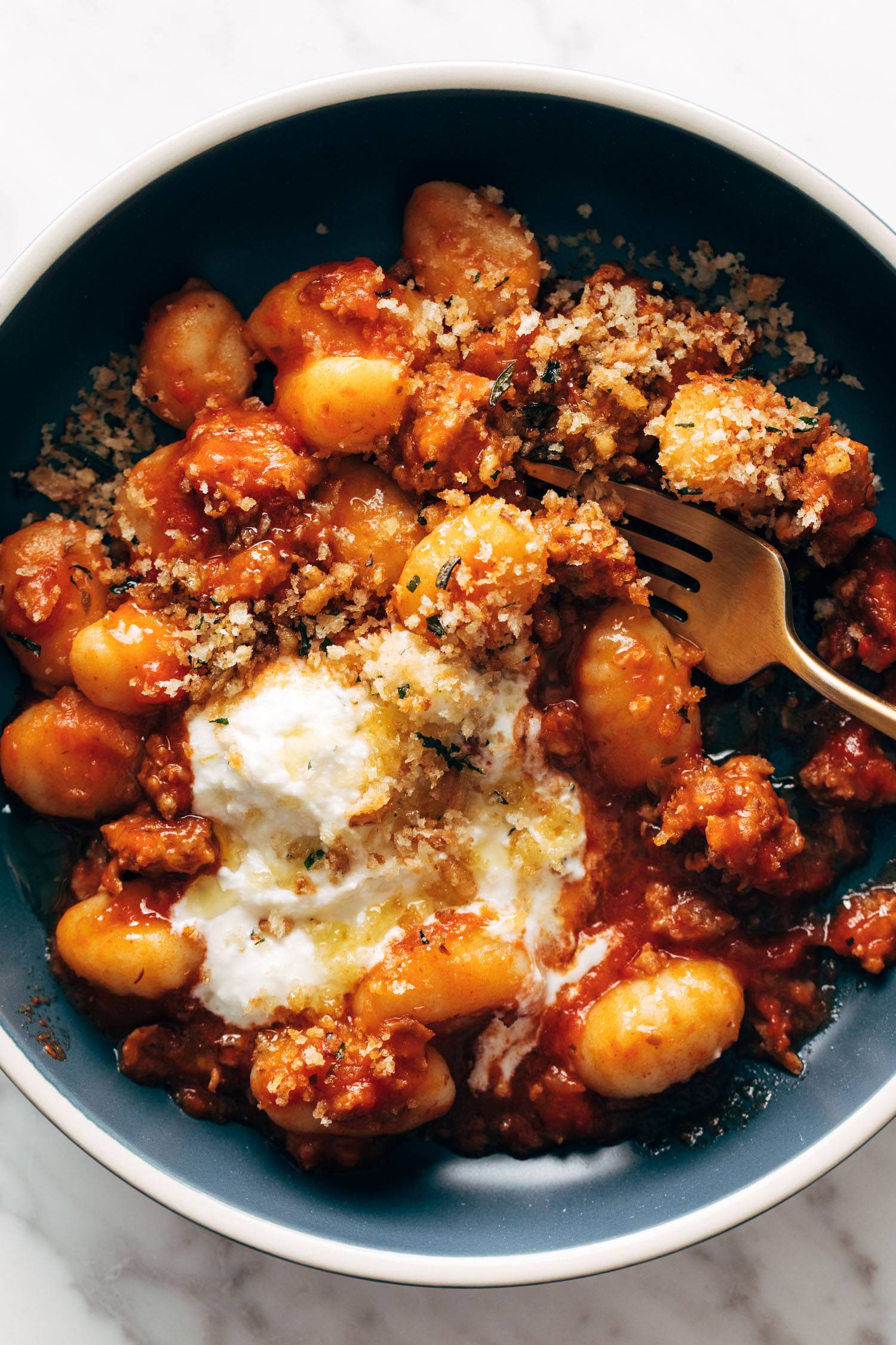 Gnocchi with red sauce and ricotta in a bowl.